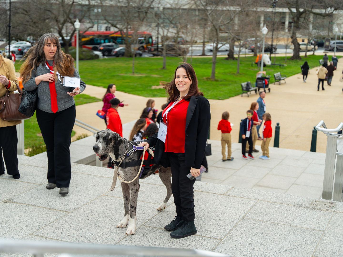 A woman with a large service dog attending Washington Days