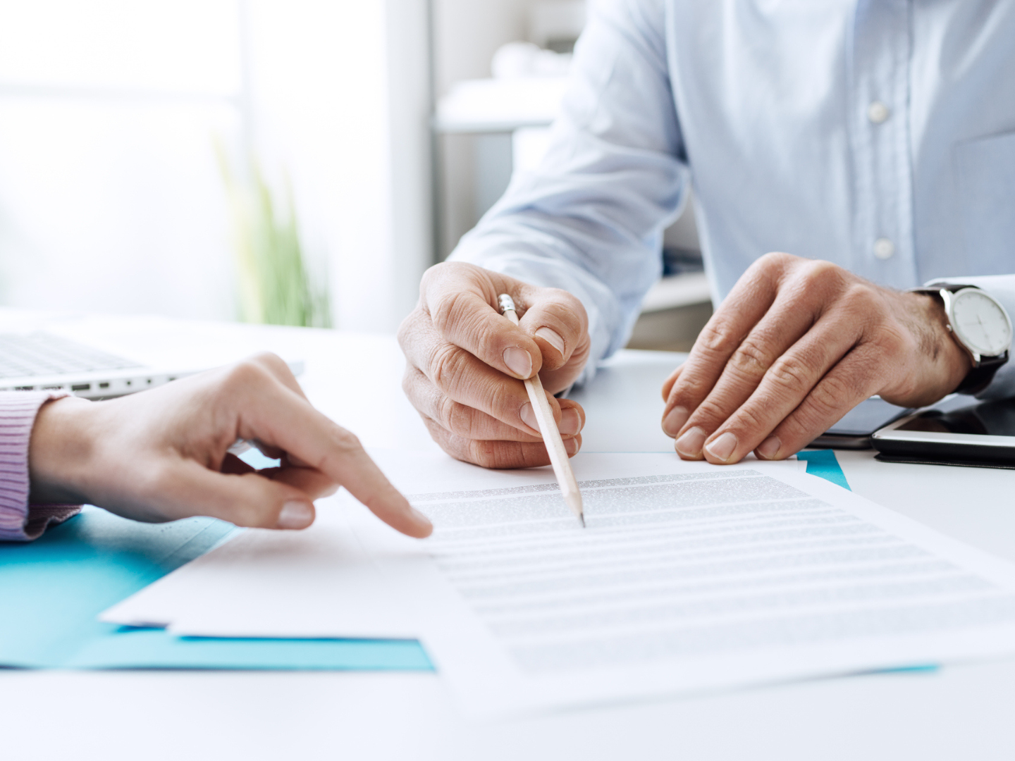 Two people reviewing a legal document