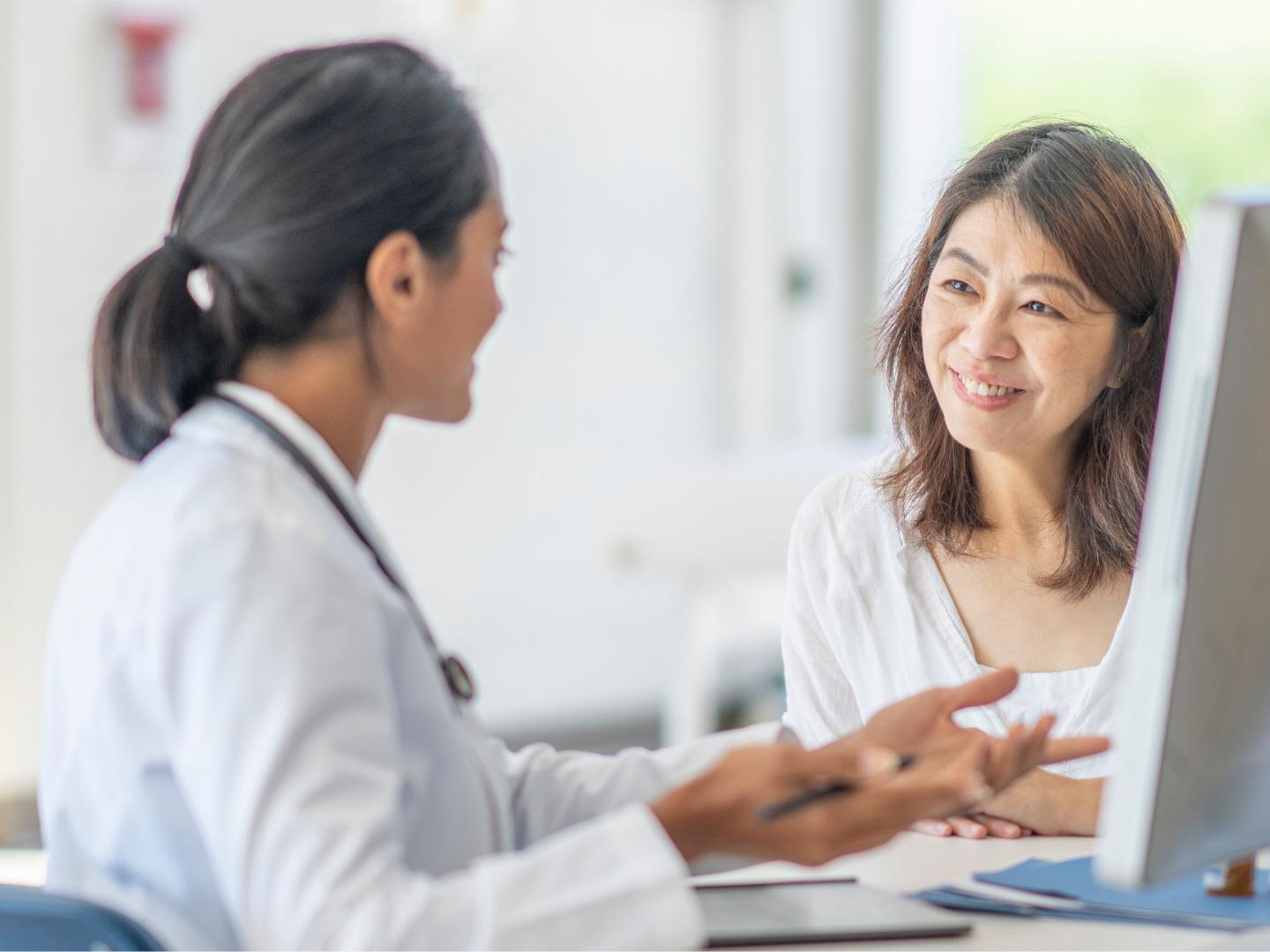 Doctor looking at document with patient